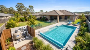 Residential swimming pool and adjacent pool pump equipment pad in South East Queensland.